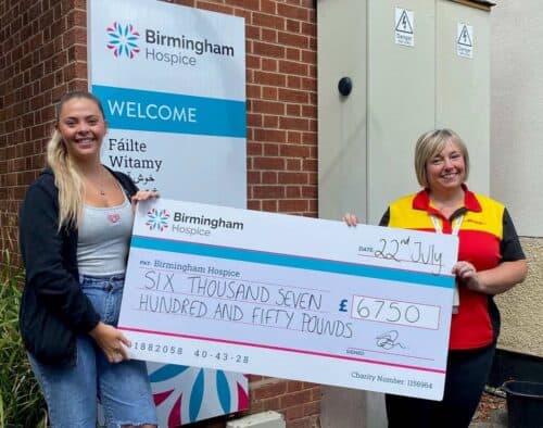 Two women holding a large cheque worth £6,750 which will be donated to Birmingham Hospice.